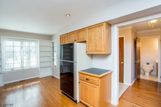 a kitchen with stainless steel appliances a refrigerator and a stove top oven