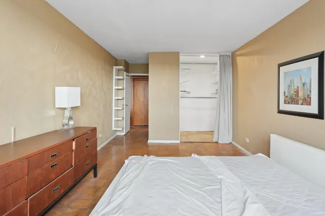 a bedroom with a bed and a dresser