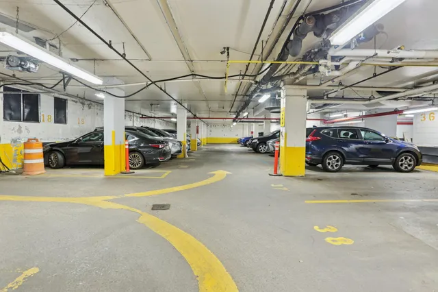 a view of parking garage with cars