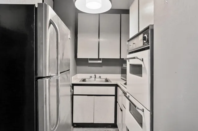 a kitchen with a refrigerator sink and stove