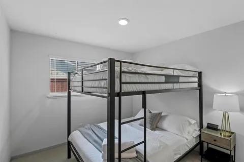 3130 Barton Road Carrollton, TX 75007 - Photo 14 of 16 a bedroom with a bed and a chandelier