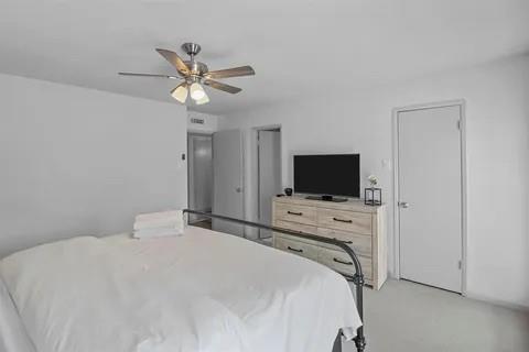 3130 Barton Road Carrollton, TX 75007 - Photo 8 of 16 a bedroom with a bed and a flat screen tv