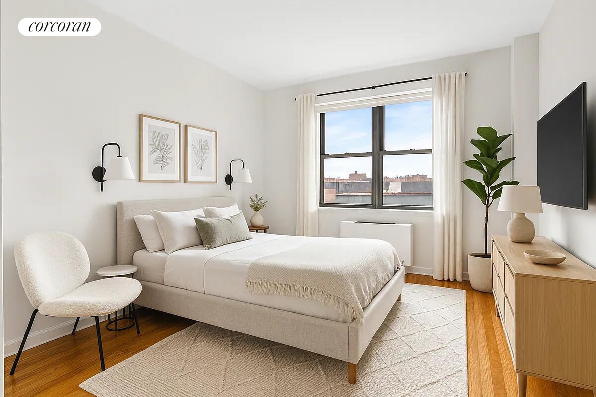 41-02 Queens Boulevard, Unit 4E Queens, NY 11104 - Photo 2 of 5 a bedroom with a bed a flat tv screen and a dresser