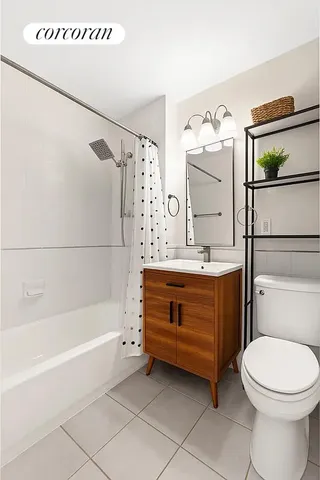 a bedroom with a bed a flat tv screen and a dresser