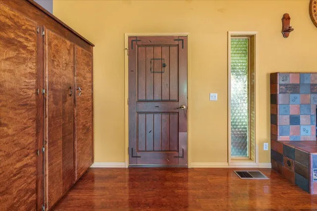 a view of front door with wooden floor
