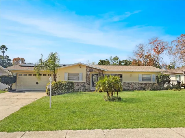 a front view of house with yard and green space
