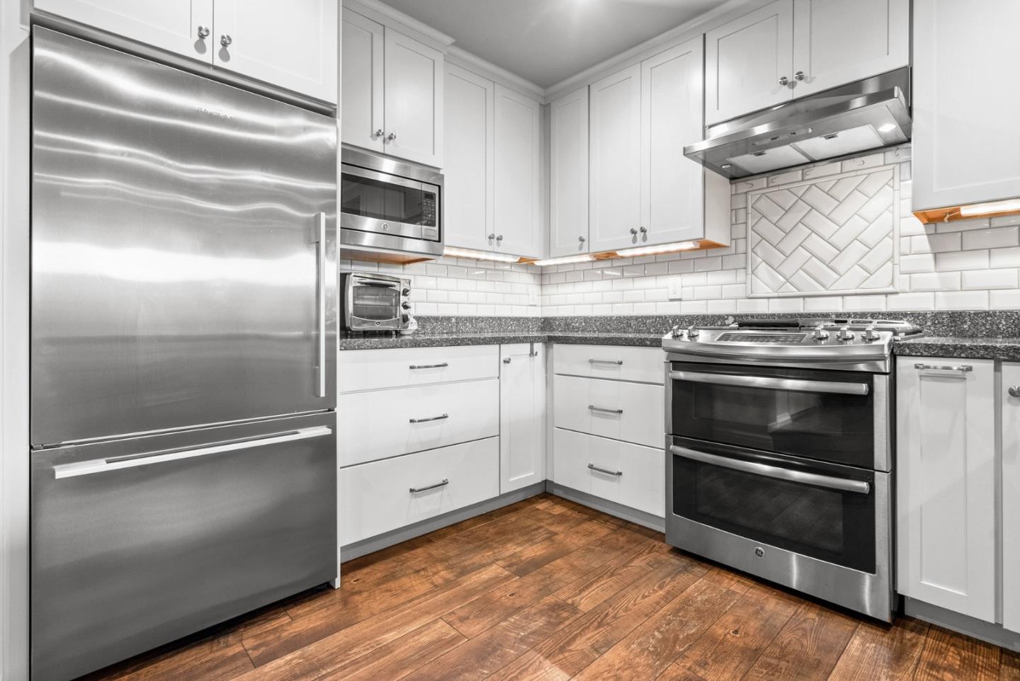 3071 Arlington Drive Aptos, CA 95003 - Photo 16 of 54 a kitchen with granite countertop stainless steel appliances and wooden floor
