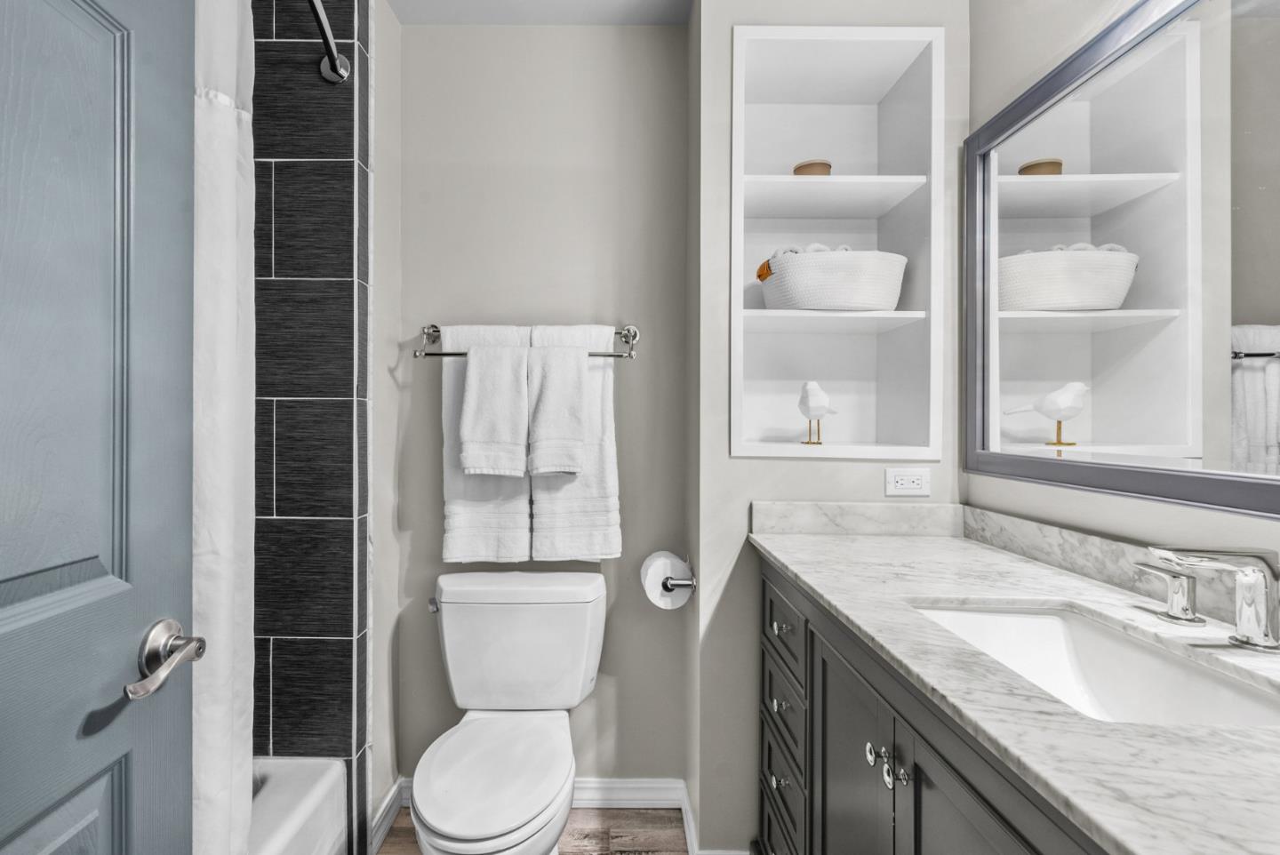 3071 Arlington Drive Aptos, CA 95003 - Photo 32 of 54 a bathroom with a granite countertop toilet sink and mirror