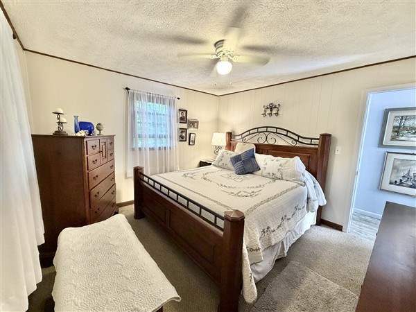 238 Trails End Road Blue Ridge, GA 30513 - Photo 13 of 32 a bedroom with a bed and dresser with mirror