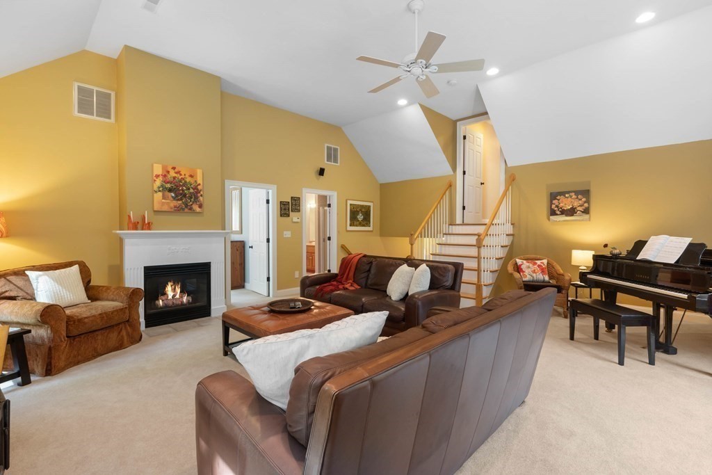 87 B Topsfield Road Boxford, MA 01921 - Photo 20 of 41 a living room with furniture a fireplace and a dining table with wooden floor