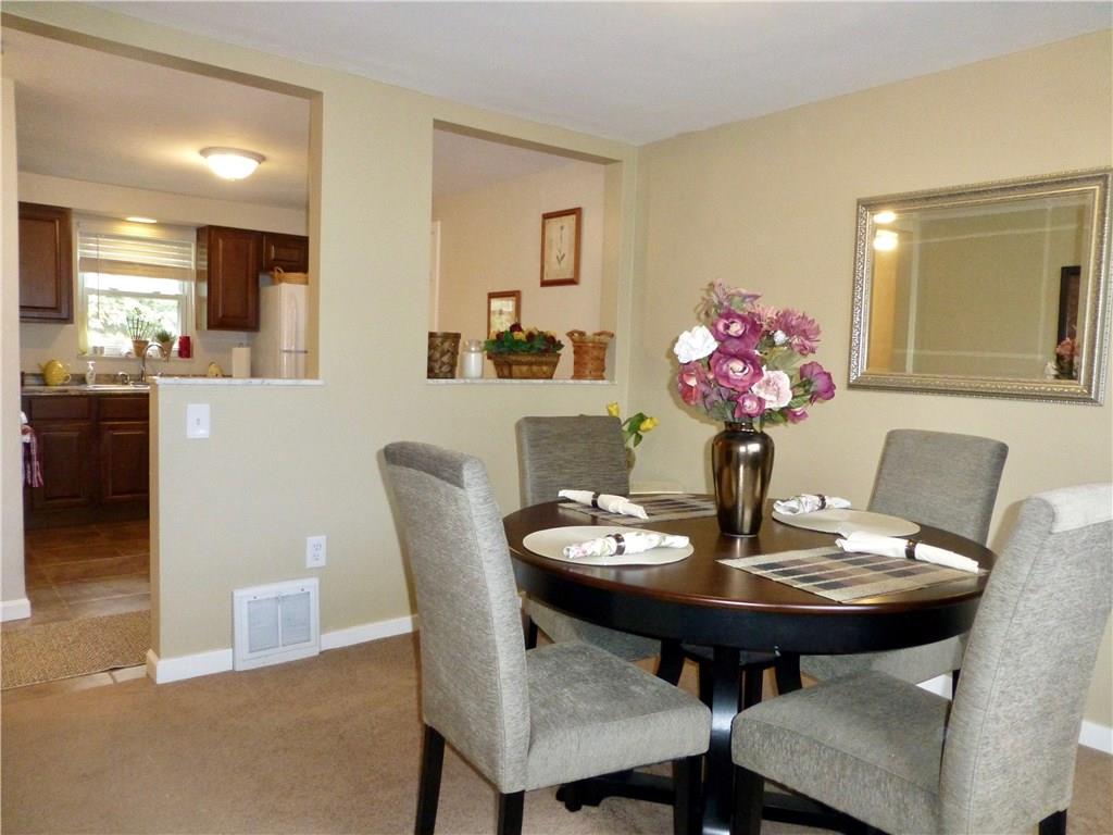Dining room with kitchen in the background