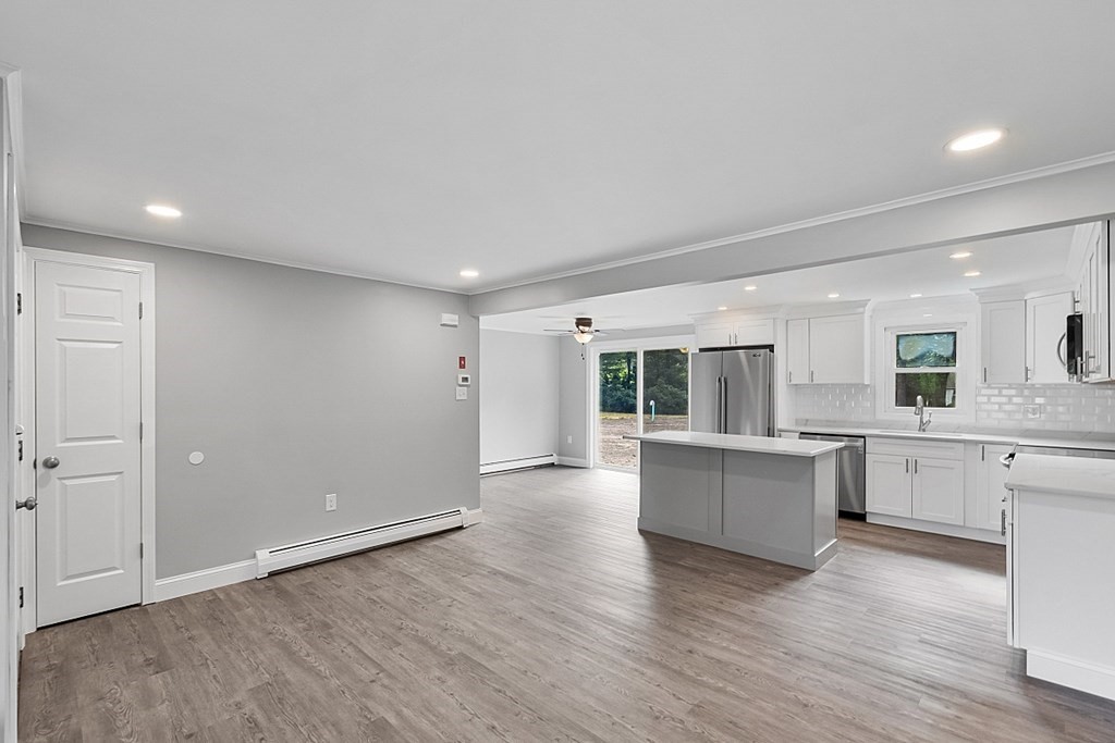 162 Memory Lane Orange, MA 01364 - Photo 10 of 41 a view of a kitchen with furniture and wooden floor