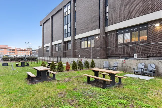 a couple of chairs and a table in backyard of the house