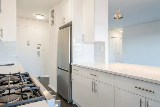 a kitchen with a refrigerator and a stove