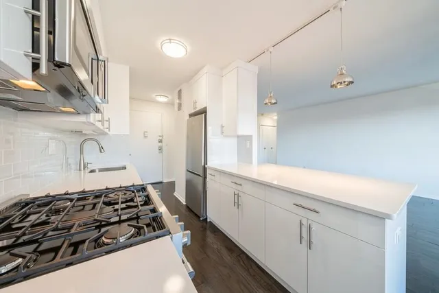 a kitchen with stainless steel appliances a sink and a stove