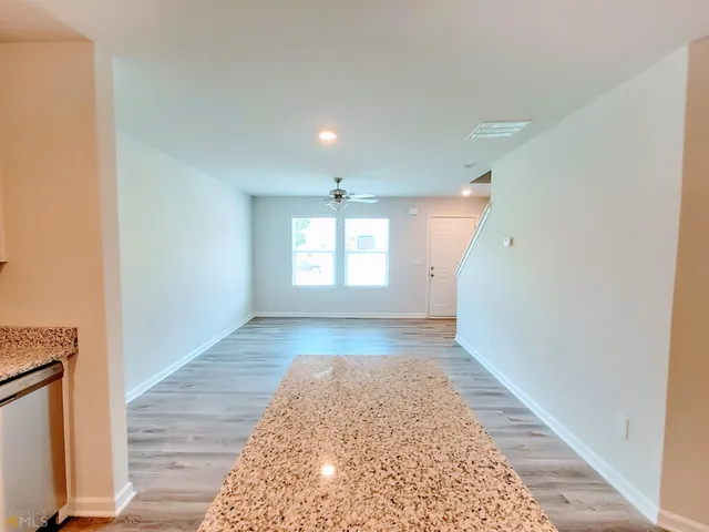 a view of hallway with window and stairs