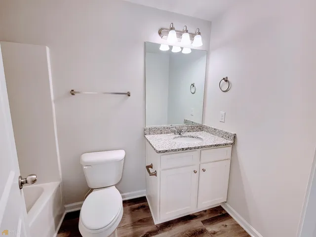 an empty room with fan and windows