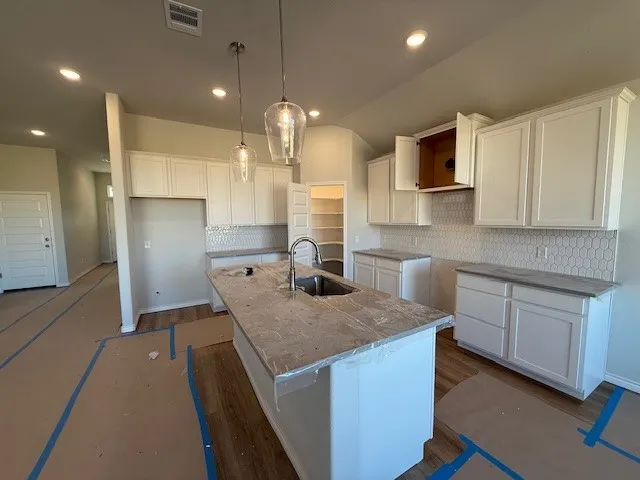 a kitchen with cabinets and stainless steel appliances