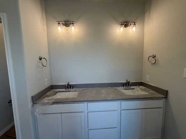 7802 Redbud Road Navasota, TX 77868 - Photo 21 of 24 a bathroom with a granite countertop sink and mirror