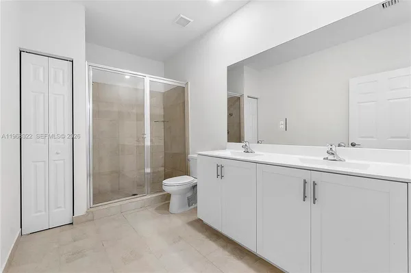 a bathroom with a shower sink and mirror