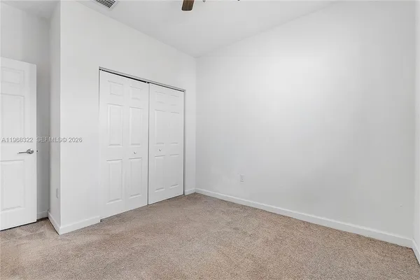 an empty room with closet area