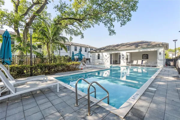 a view of a patio with table and chairs and potted plants