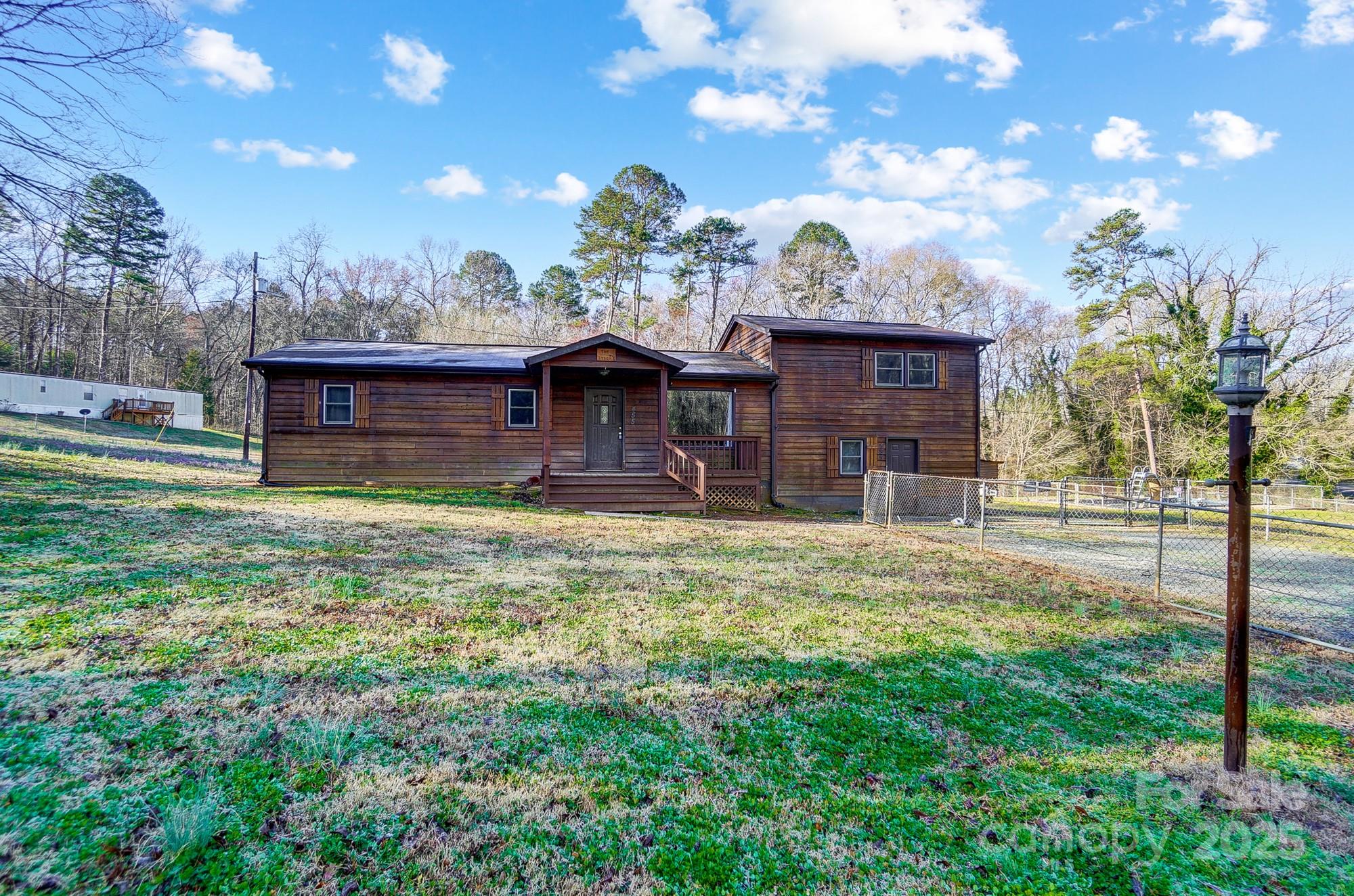 a view of a house with a backyard porch and sitting area