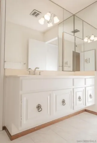 a bathroom with a sink a vanity and a mirror