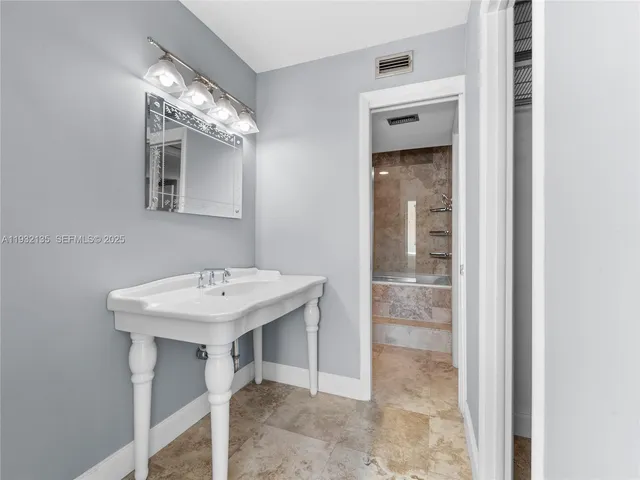 a bathroom with a sink a mirror and a shower