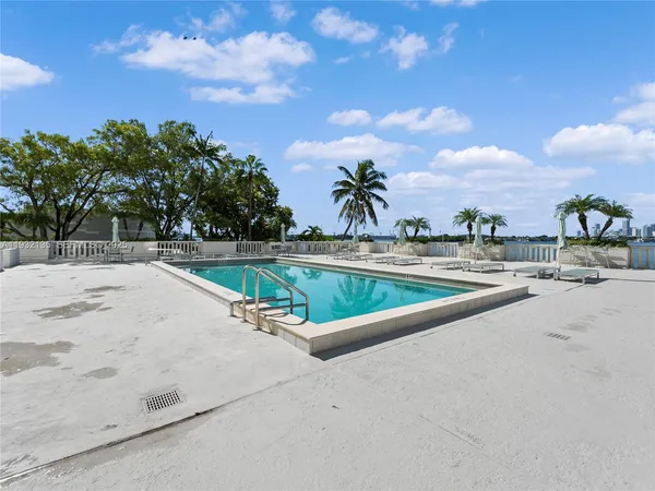 a view of a swimming pool with a yard