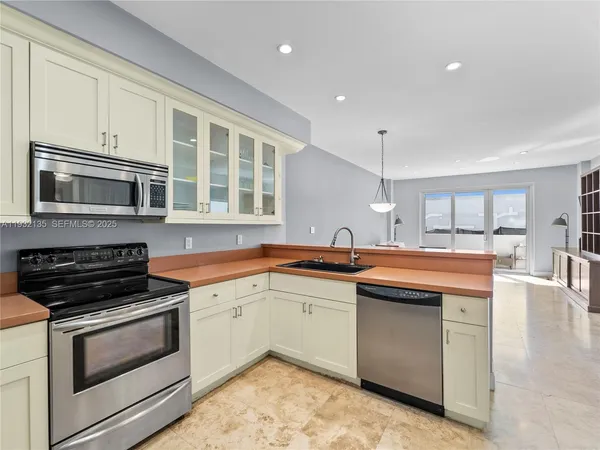 a kitchen with stainless steel appliances granite countertop a stove and a sink