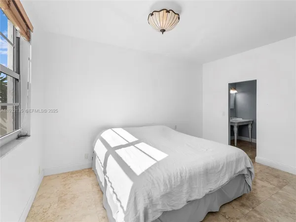 a bedroom with a bed and a table