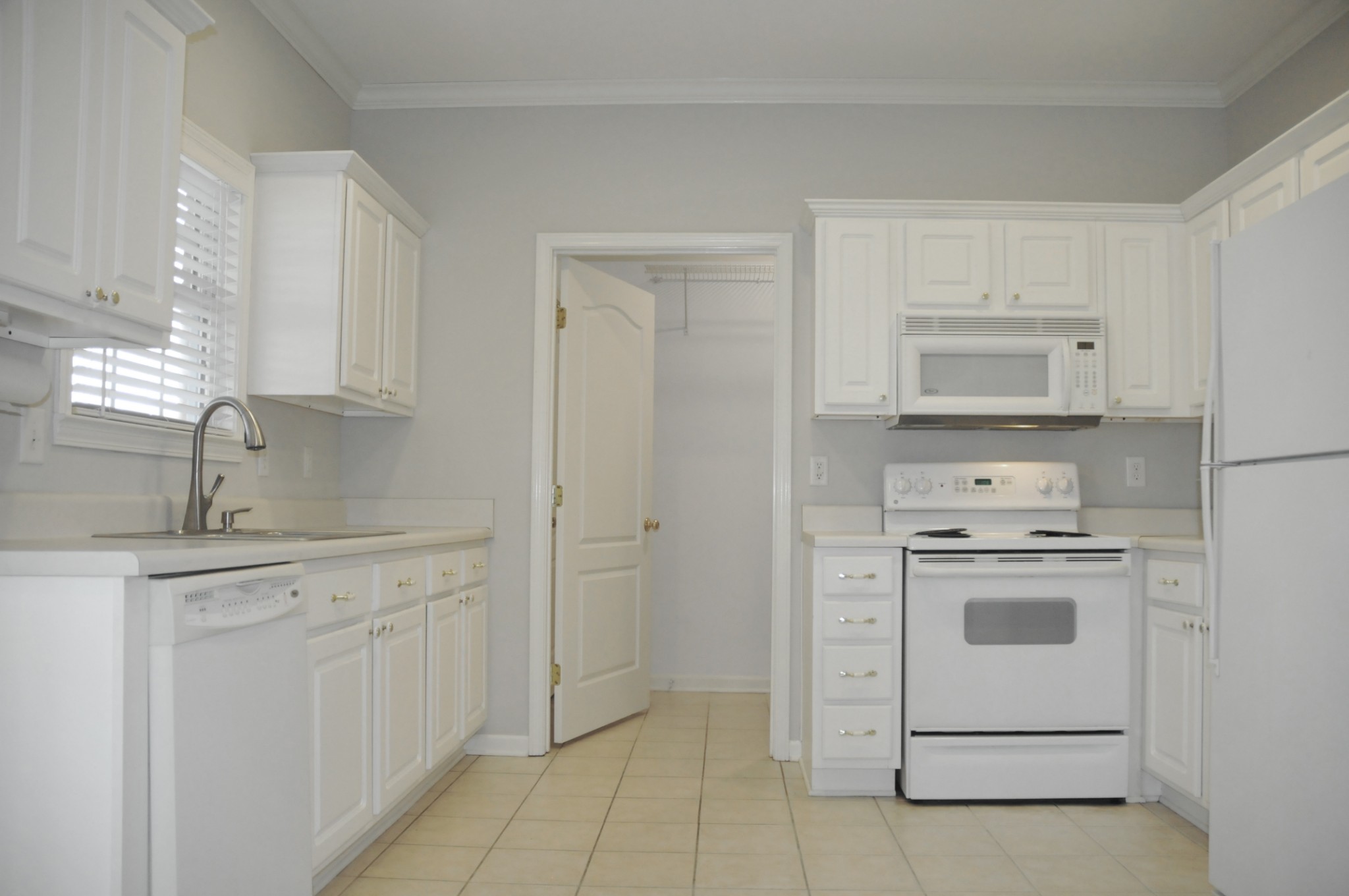 7101 Fernvale Springs Way Fairview, TN 37062 - Photo 9 of 18 a kitchen with white cabinets and white appliances