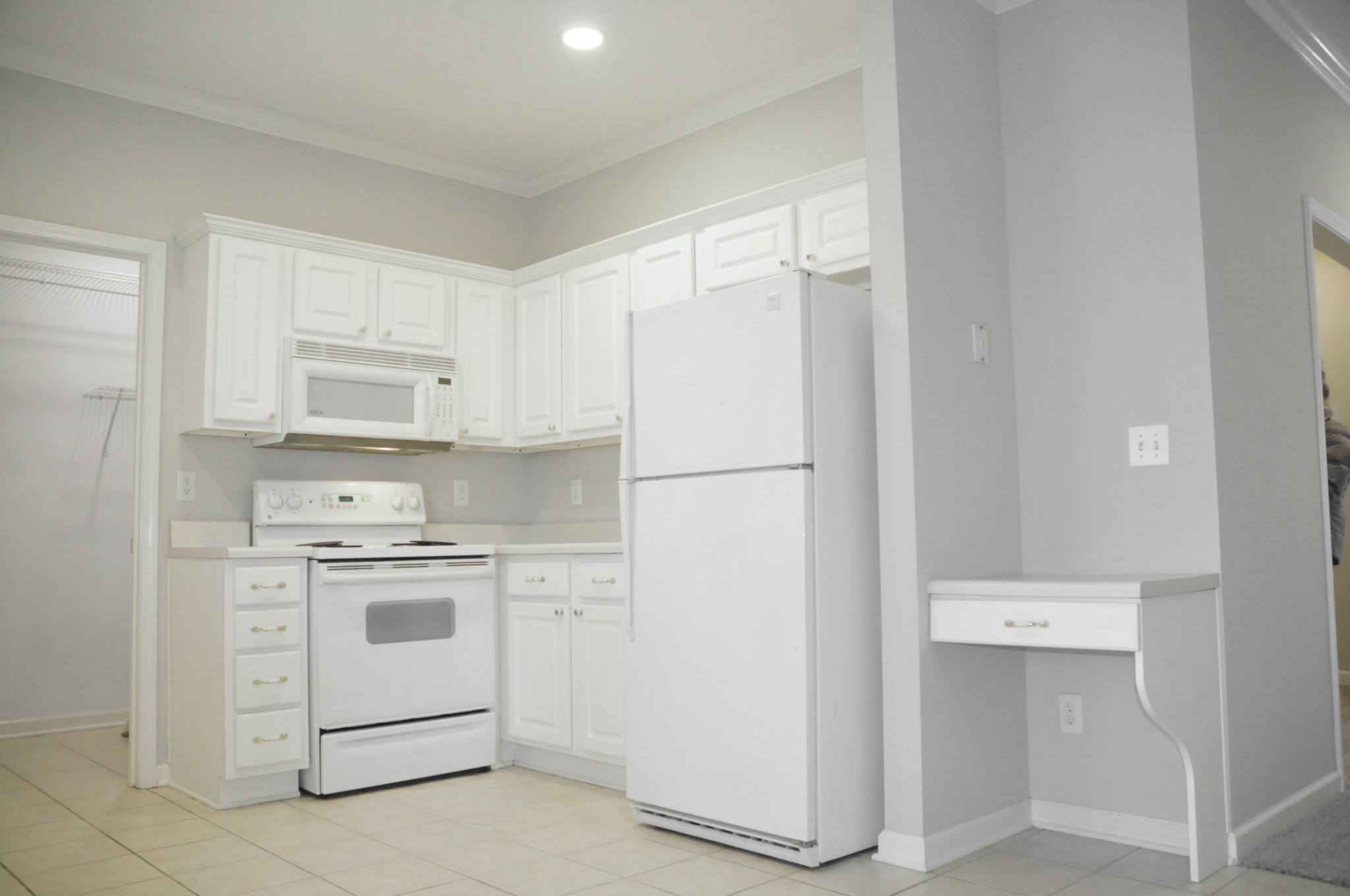 7101 Fernvale Springs Way Fairview, TN 37062 - Photo 10 of 18 a kitchen with a stove a refrigerator and white cabinets