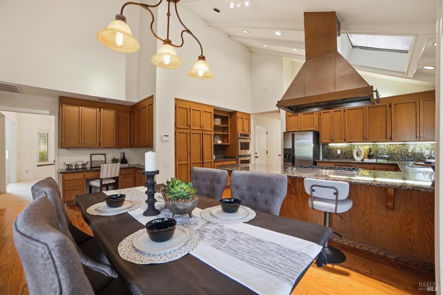 2656 Fir Park Way Santa Rosa, CA 95404 - Photo 16 of 51 a kitchen with stainless steel appliances granite countertop a stove a kitchen island a dining table and chairs with wooden floor