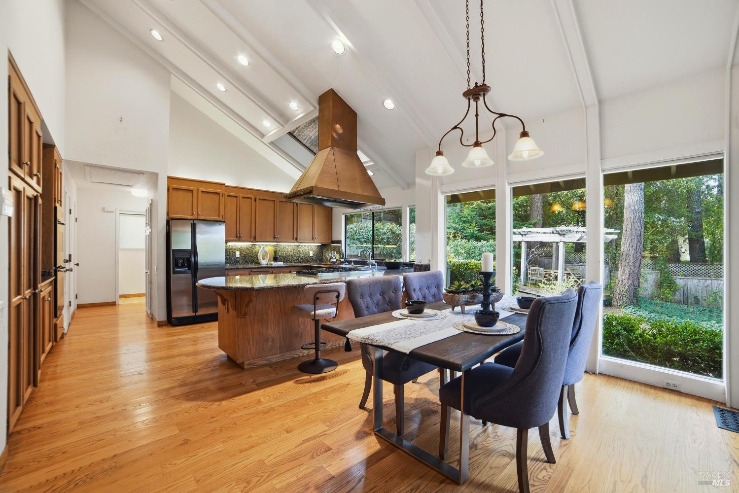 2656 Fir Park Way Santa Rosa, CA 95404 - Photo 17 of 51 a dining room with wooden floor a chandelier a wooden table and chairs