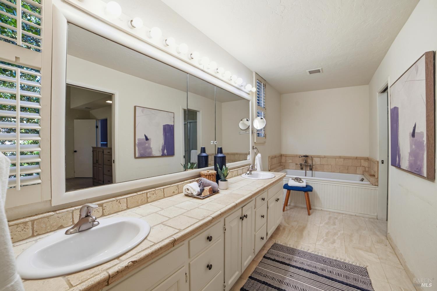 2656 Fir Park Way Santa Rosa, CA 95404 - Photo 33 of 51 a bathroom with a double vanity sink a mirror and a bathtub