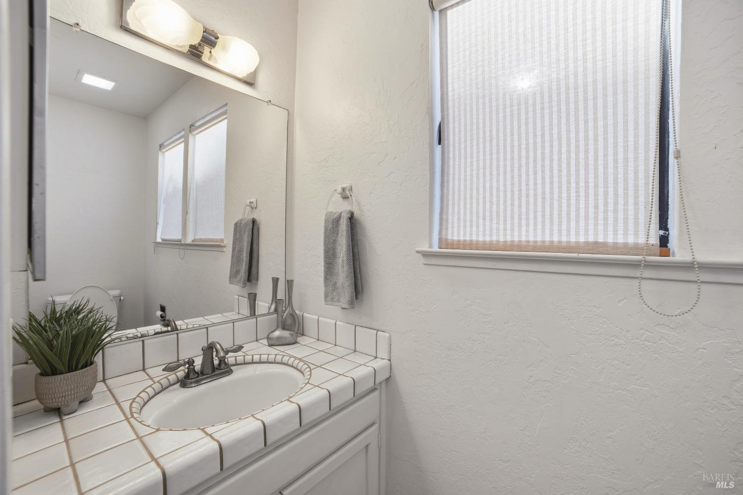 2656 Fir Park Way Santa Rosa, CA 95404 - Photo 35 of 51 a bathroom with a sink and a mirror
