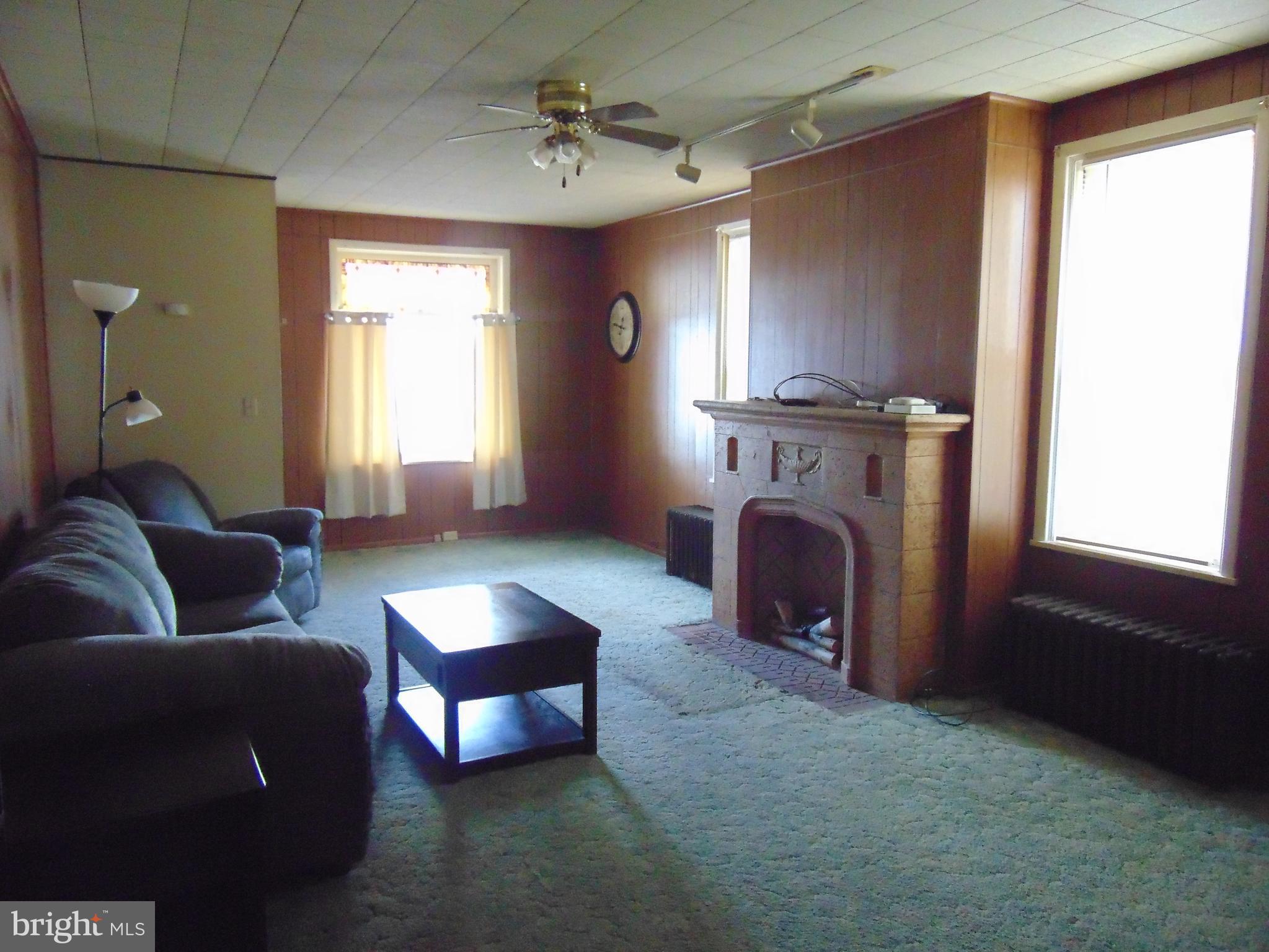 24 East Ridge Street Coaldale, PA 18218 - Photo 23 of 38 a living room with furniture a window and a fireplace