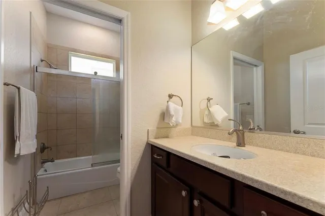 a bathroom with a double vanity sink mirror and bathtub
