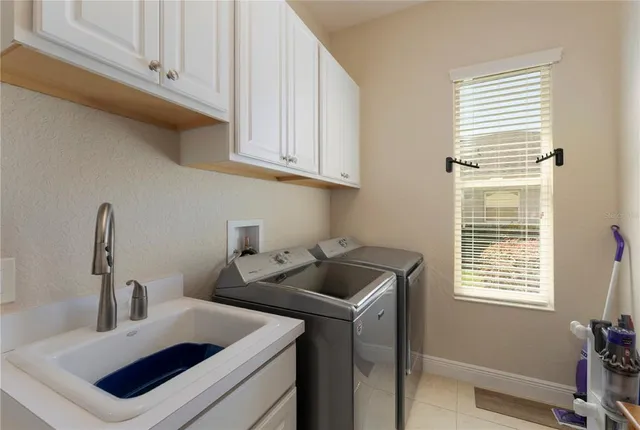 a kitchen with cabinets appliances a sink and a window