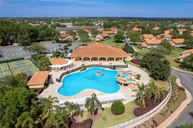 an aerial view of residential houses with outdoor space and street view