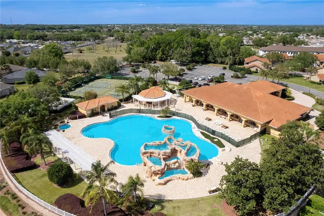 an aerial view of a house with a swimming pool yard and outdoor seating