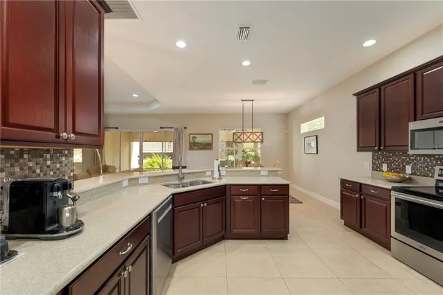 a kitchen with stainless steel appliances granite countertop a stove sink and cabinets