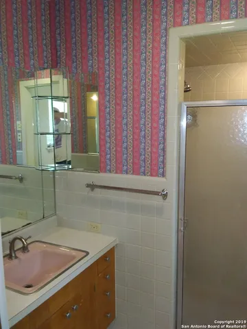 a bathroom with a toilet and a window