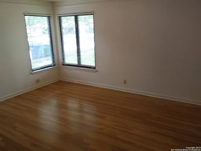 a view of a bathroom with a shower curtain and a chandelier