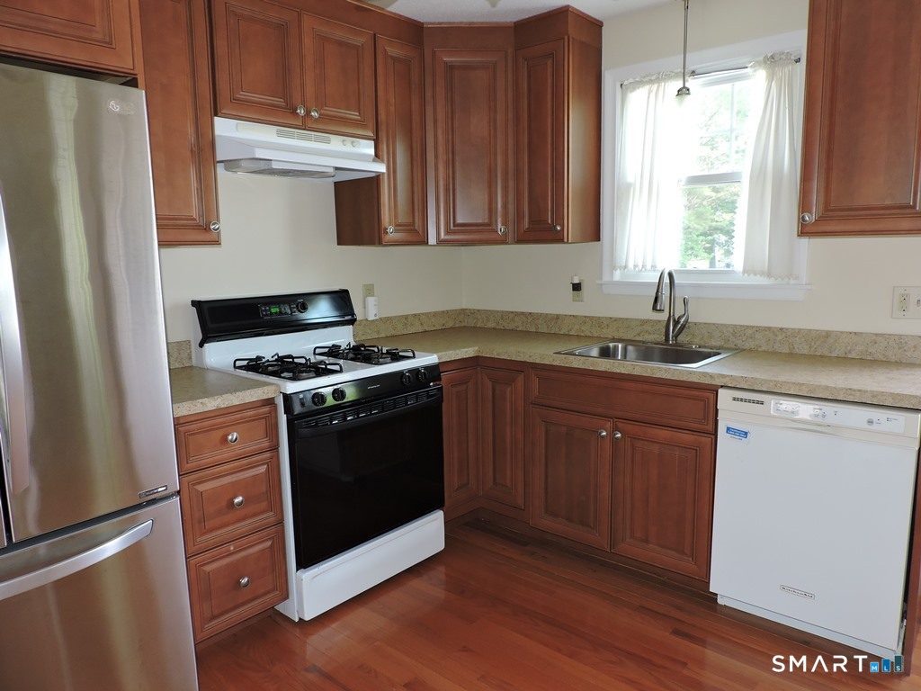 269 Griffin Road South Windsor, CT 06074 - Photo 6 of 36 a kitchen with granite countertop a sink cabinets and stainless steel appliances