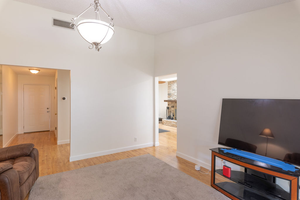 5310 Presidio Road Austin, TX 78745 - Photo 11 of 34 A welcoming interior with gleaming hardwood floors, creating a seamless flow between rooms.