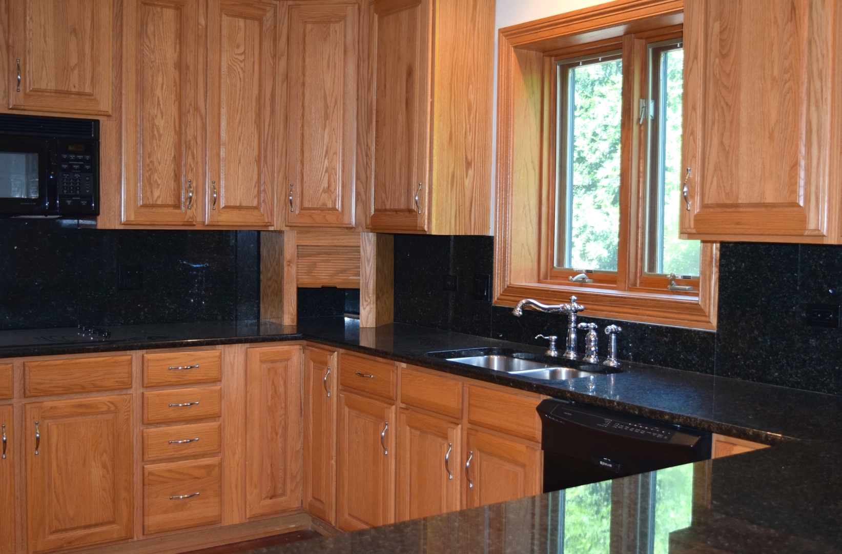 421 Lewis Road Geneva, IL 60134 - Photo 4 of 17 a kitchen with granite countertop a sink window and cabinets