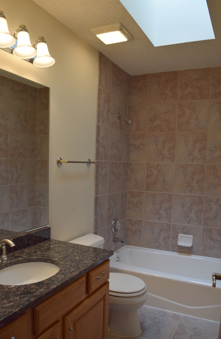421 Lewis Road Geneva, IL 60134 - Photo 8 of 17 a bathroom with a granite countertop sink toilet and shower